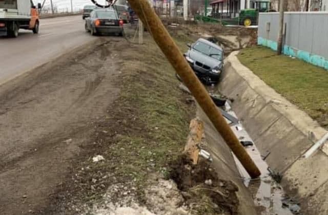 Accident! Doi tineri au rupt un stâlp și au ajuns cu mașina în șanț