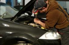 Mecanic auto cercetat pentru reparații la o mașină implicată într-un accident