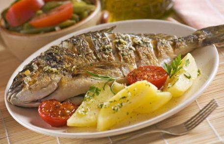 Crap la cuptor în sos de vin şi cartofi natur